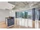 Bright living room boasts concrete ceilings and floor-to-ceiling windows overlooking the cityscape at 950 W Peachtree Nw St # 812, Atlanta, GA 30309
