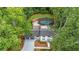 Aerial view of home surrounded by lush green trees at 9805 Buice Rd, Alpharetta, GA 30022