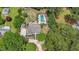 Aerial shot reveals a large lot with a pool, patio, play area, and beautiful landscaping at 9805 Buice Rd, Alpharetta, GA 30022