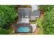 Aerial view of a home featuring a backyard pool, large deck, and lush greenery at 9805 Buice Rd, Alpharetta, GA 30022