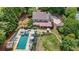 Aerial view of a backyard featuring a swimming pool, hot tub, and outdoor seating area at 9805 Buice Rd, Alpharetta, GA 30022