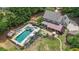 Overhead shot reveals a private pool with a hot tub, lounging area, and covered patio space at 9805 Buice Rd, Alpharetta, GA 30022