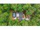 Aerial view showcasing lush greenery surrounding a private home with a backyard pool at 9805 Buice Rd, Alpharetta, GA 30022