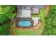 Birds-eye view of a home with a covered pool, spacious deck, and green landscaping at 9805 Buice Rd, Alpharetta, GA 30022