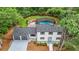 Aerial view of home with well-manicured lawn, pool, and two-car garage at 9805 Buice Rd, Alpharetta, GA 30022
