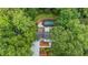 Aerial perspective of home with an in-ground pool, garage, and private, tree-surrounded backyard at 9805 Buice Rd, Alpharetta, GA 30022