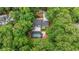 Aerial view of a home with a pool surrounded by mature trees and greenery at 9805 Buice Rd, Alpharetta, GA 30022