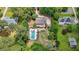 Aerial perspective highlights a private pool, hot tub, extensive patio area, and lush landscaping at 9805 Buice Rd, Alpharetta, GA 30022