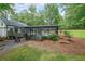 A sprawling backyard showcases a stylish home with a screened-in pool and lush greenery, great for outdoor enjoyment at 9805 Buice Rd, Alpharetta, GA 30022