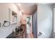 Bathroom featuring a long vanity with double sinks and decorative mirrors at 9805 Buice Rd, Alpharetta, GA 30022