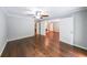Well-lit room featuring hardwood floors, a ceiling fan and access to the bathroom and living room at 9805 Buice Rd, Alpharetta, GA 30022