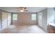 Bedroom featuring carpet, a ceiling fan, and windows with a built-in desk area at 9805 Buice Rd, Alpharetta, GA 30022