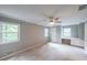 Bedroom featuring carpet, a ceiling fan, and windows with a built-in desk area at 9805 Buice Rd, Alpharetta, GA 30022