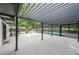 A covered outdoor deck showcases a pool enclosure, outdoor kitchen, and spacious area for entertaining or relaxing at 9805 Buice Rd, Alpharetta, GA 30022