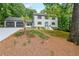 Charming two-story home featuring a two-car garage, blue front door and well-maintained landscaping at 9805 Buice Rd, Alpharetta, GA 30022