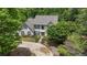 Charming two-story home with a lush green lawn, mature trees, and a circular driveway at 9805 Buice Rd, Alpharetta, GA 30022