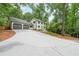 Exterior view of traditional two-story home, featuring a long driveway and a two-car garage at 9805 Buice Rd, Alpharetta, GA 30022