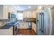Updated kitchen showcasing stainless steel appliances and granite countertops at 9805 Buice Rd, Alpharetta, GA 30022