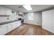 Kitchen featuring white cabinets, black countertops, stainless appliances, and white subway tile at 9805 Buice Rd, Alpharetta, GA 30022