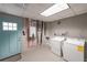 Laundry room with machines and a utility door at 9805 Buice Rd, Alpharetta, GA 30022