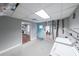 Utility area with laundry machines, blue door, and view to the kitchen at 9805 Buice Rd, Alpharetta, GA 30022