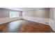 Spacious living room with hardwood floors, wainscoting, and a large window at 9805 Buice Rd, Alpharetta, GA 30022