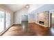 Bright open living space with hardwood floors, high ceiling, a fireplace, and access to backyard at 9805 Buice Rd, Alpharetta, GA 30022