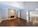 Spacious living room boasts hardwood floors, stone fireplace, and seamless flow into adjacent rooms at 9805 Buice Rd, Alpharetta, GA 30022