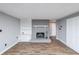 Living room featuring wood floors and grey brick fireplace with built-in shelving at 9805 Buice Rd, Alpharetta, GA 30022