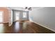 Cozy living room with hardwood floors, neutral walls, ceiling fan, and access to the backyard at 9805 Buice Rd, Alpharetta, GA 30022