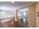 Spacious living room with hardwood floors, wainscoting and open to other rooms at 9805 Buice Rd, Alpharetta, GA 30022
