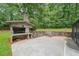 Inviting backyard boasts a brick outdoor kitchen and a stone-lined patio, perfect for entertaining at 9805 Buice Rd, Alpharetta, GA 30022