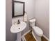 Cozy half bath with a pedestal sink and updated fixtures at 9805 Buice Rd, Alpharetta, GA 30022