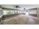 Sunroom featuring tile floors, lots of windows and two ceiling fans at 9805 Buice Rd, Alpharetta, GA 30022