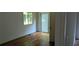 Bedroom with hardwood floors, window, and access to the outside at 1092 Hillcrest Se Dr, Atlanta, GA 30316