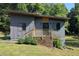 Striking modern home featuring sleek gray siding, wooden accents, and a beautifully landscaped entrance at 1092 Hillcrest Se Dr, Atlanta, GA 30316