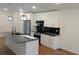 Bright kitchen boasts white cabinets, stainless appliances, black backsplash, and a marble island at 1092 Hillcrest Se Dr, Atlanta, GA 30316