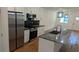 Modern kitchen featuring stainless steel appliances, a large island, and white cabinetry at 1092 Hillcrest Se Dr, Atlanta, GA 30316
