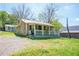 Charming exterior of a house with a cozy porch and a well-maintained front yard at 1422 Cassville Nw Rd, Cartersville, GA 30121