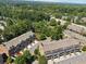 Aerial view showcasing multiple townhomes in a neighborhood with mature trees and landscaping, perfect for outdoor living at 2520 Carmel Way, Alpharetta, GA 30009