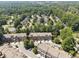 Extensive aerial view of townhomes in a neighborhood surrounded by green trees showcasing community layout and serene settings at 2520 Carmel Way, Alpharetta, GA 30009