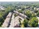 Wide aerial shot of residential area features townhomes nestled among lush trees, providing a tranquil community atmosphere at 2520 Carmel Way, Alpharetta, GA 30009