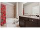 Bathroom with a tub and shower, granite counters and dark wood cabinets at 2520 Carmel Way, Alpharetta, GA 30009