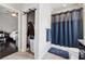 Bathroom featuring toilet, shower with blue curtain, and closet leading to bedroom at 2520 Carmel Way, Alpharetta, GA 30009