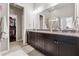 Bathroom featuring double vanity, granite countertop, and closet with shelving system at 2520 Carmel Way, Alpharetta, GA 30009