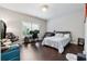 Well-lit bedroom with hardwood floors, a window, and a neutral color scheme at 2520 Carmel Way, Alpharetta, GA 30009