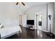 Bedroom featuring hardwood floors, grey walls, and doorways leading to bathroom and closet at 2520 Carmel Way, Alpharetta, GA 30009