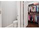 Walk-in closet featuring shelving and hanging system attached to half bathroom at 2520 Carmel Way, Alpharetta, GA 30009