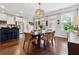 Open concept dining area near the kitchen, featuring modern lighting, hardwood floors, and natural light at 2520 Carmel Way, Alpharetta, GA 30009
