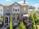 Charming brick townhome featuring a covered entrance, upper level balcony and manicured landscaping at 2520 Carmel Way, Alpharetta, GA 30009
